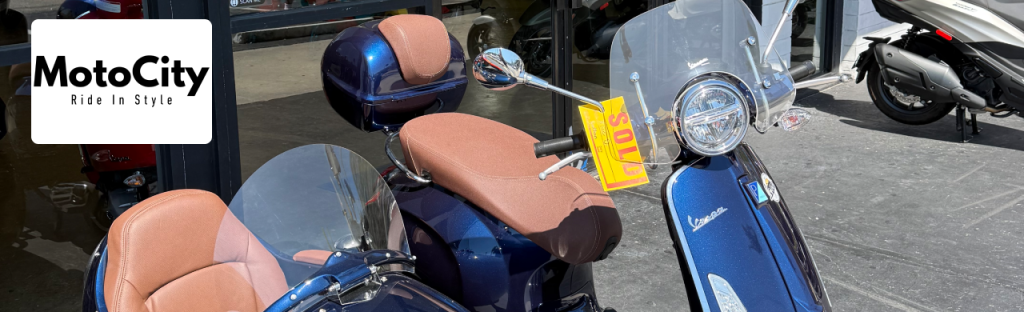 Close-up of a custom Vespa 150cc sidecar model at MotoCity Vespa Naples showroom
