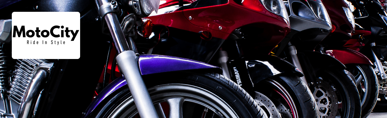 A fully assembled handmade motorcycle outside MotoCity USA in Naples, FL, showcasing chrome engine work and a matte black finish.